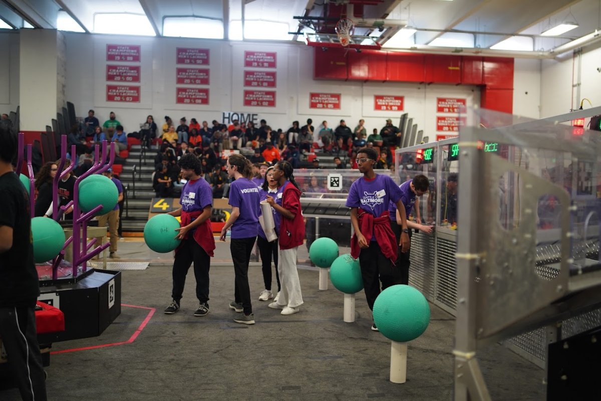 Team members engaging with young visitors at a community STEM outreach event