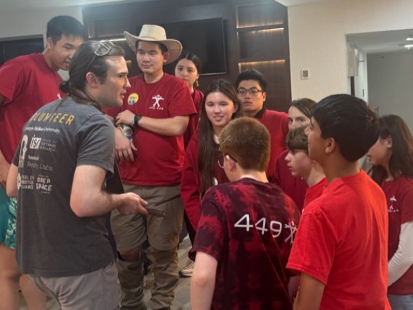 Team members and a mentor gathered together at a competition event