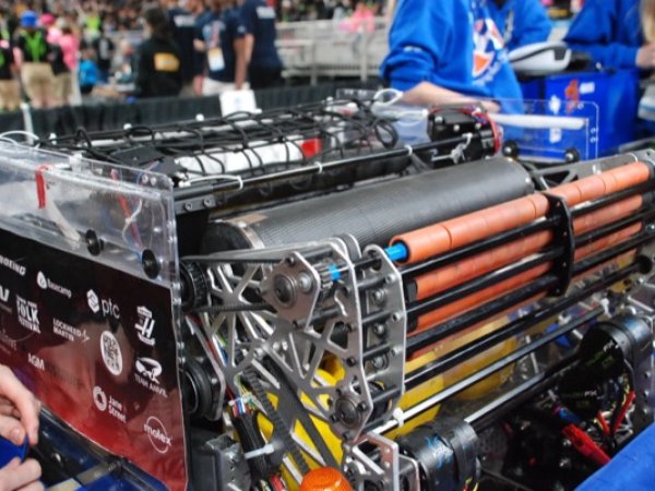 Close-up of the robot's roller mechanism, showing sponsor logos on the side panel