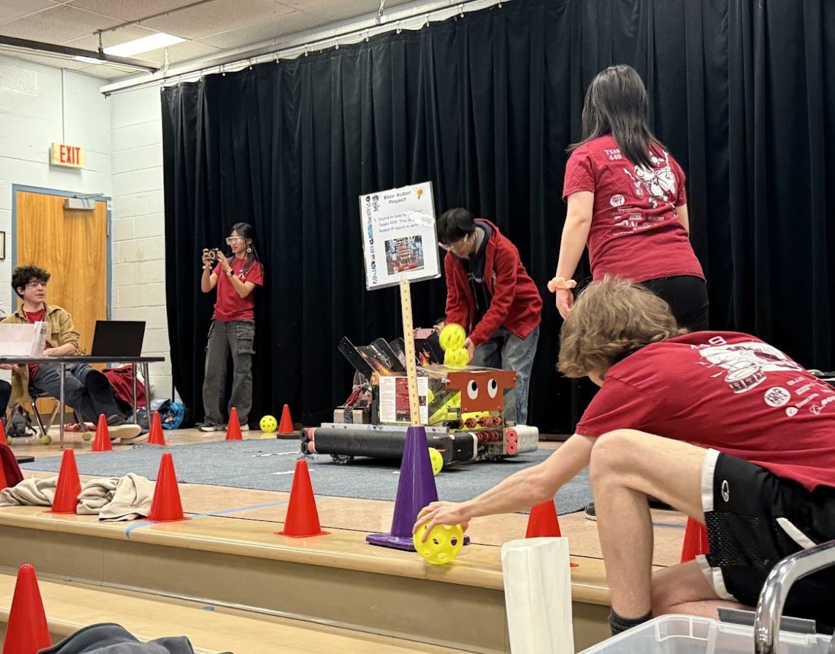 Team members engaging with young visitors at a community STEM outreach event