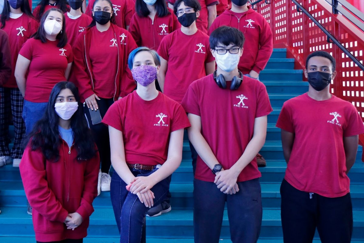 Team members in masks on the school stairwell